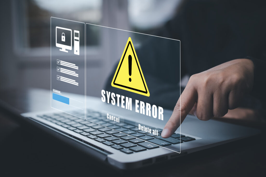 Tela de erro de sistema exibida em um laptop, com uma mensagem de alerta e opções para cancelar ou deletar todos os arquivos.